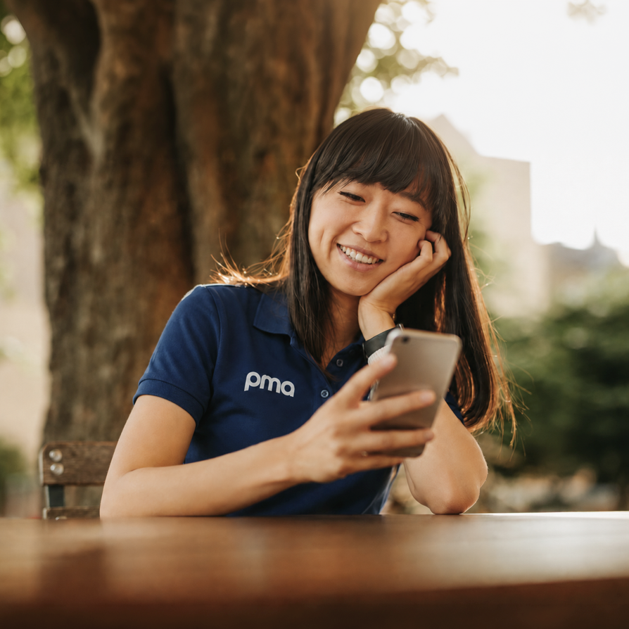 PMA customer support specialist speaking by phone while using a tablet